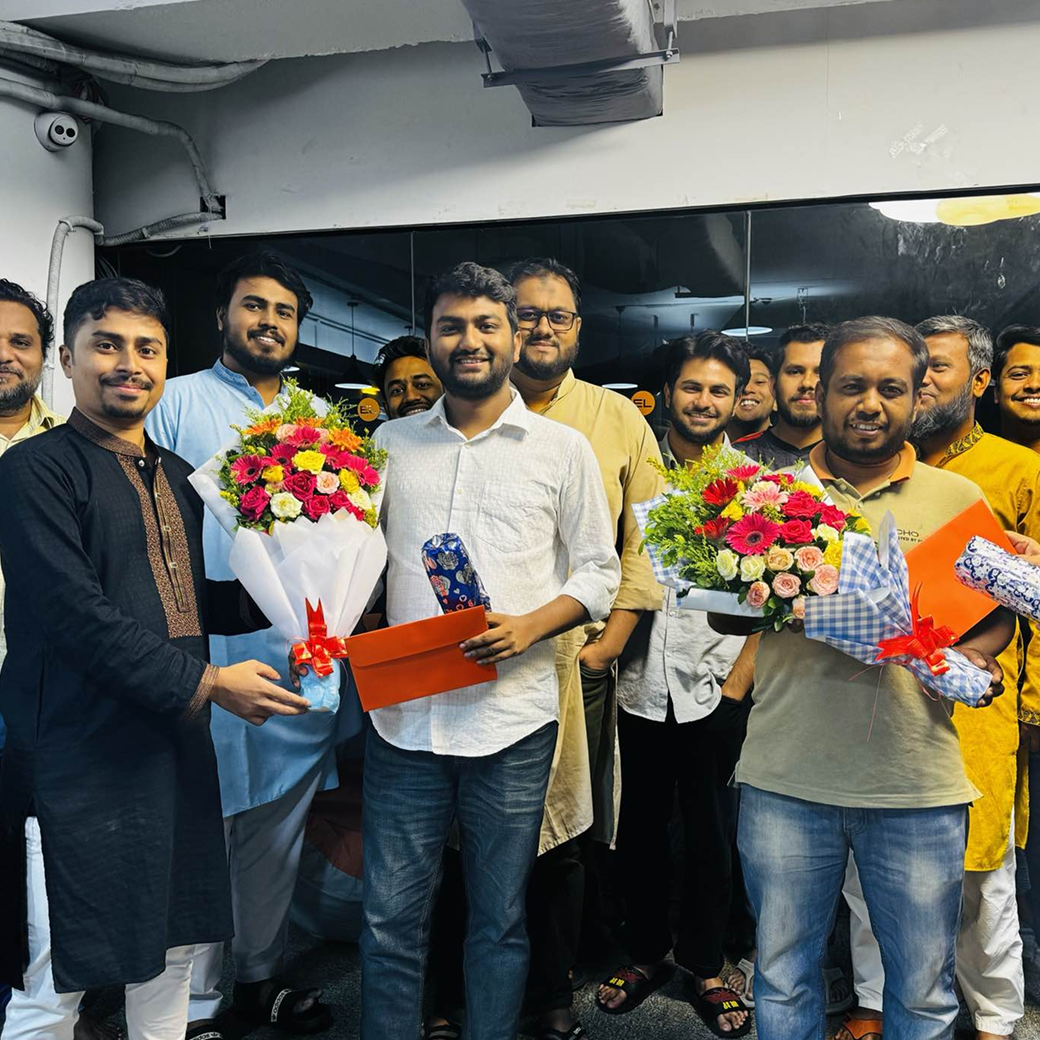 Team celebration with flowers and gifts